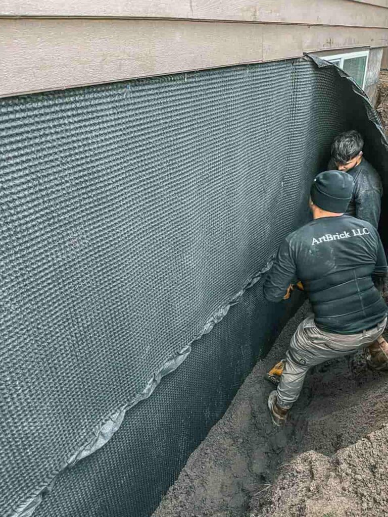 Guys from Artbrick LLC - a trusted remodeling contractor in seattle are attaching a waterproofing membrane