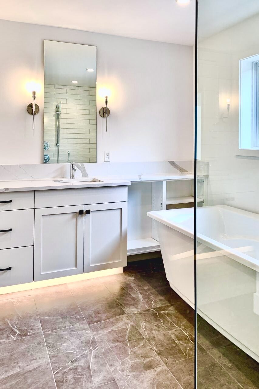 A beautifully updated bathroom showcasing a recent bathroom renovation Seattle project, featuring a modern vanity, and stylish tile work