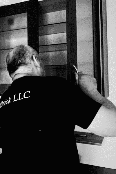 Anaolii is adjusting cabinet doors for a kitchen renovation Seattle project