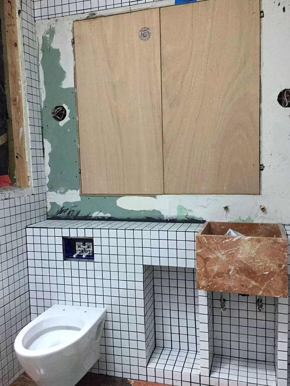 Bathroom grid tile with marble vanity by Artbrick