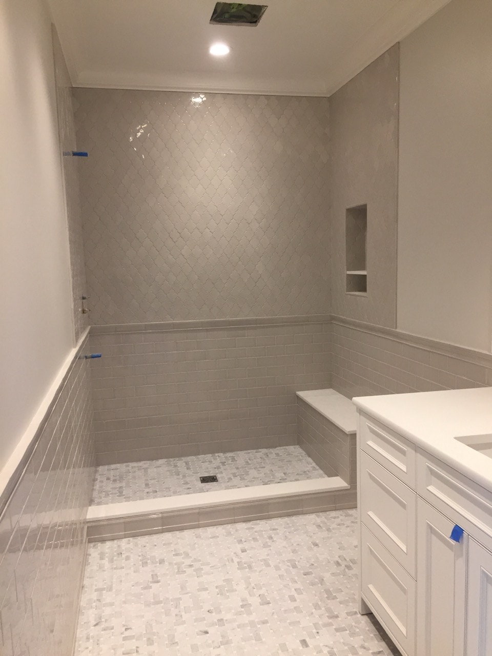 Bathroom remodel with subway tile shower and white vanity by Artbrick