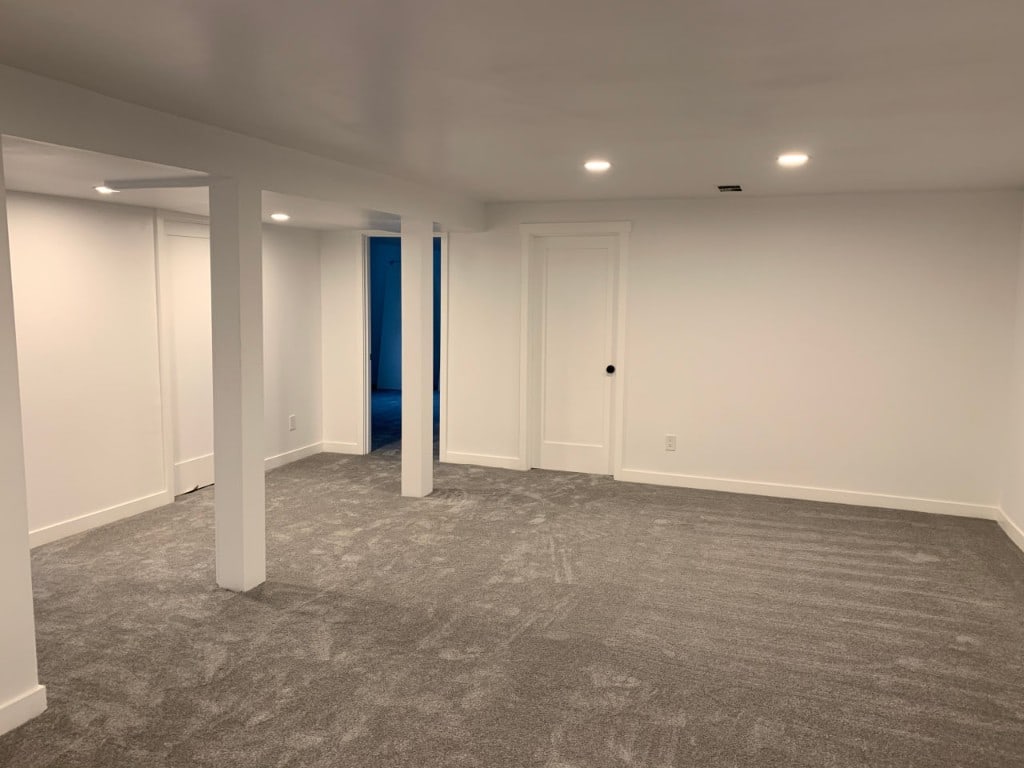 Finished basement family room with recessed lighting and new carpet by Artbrick