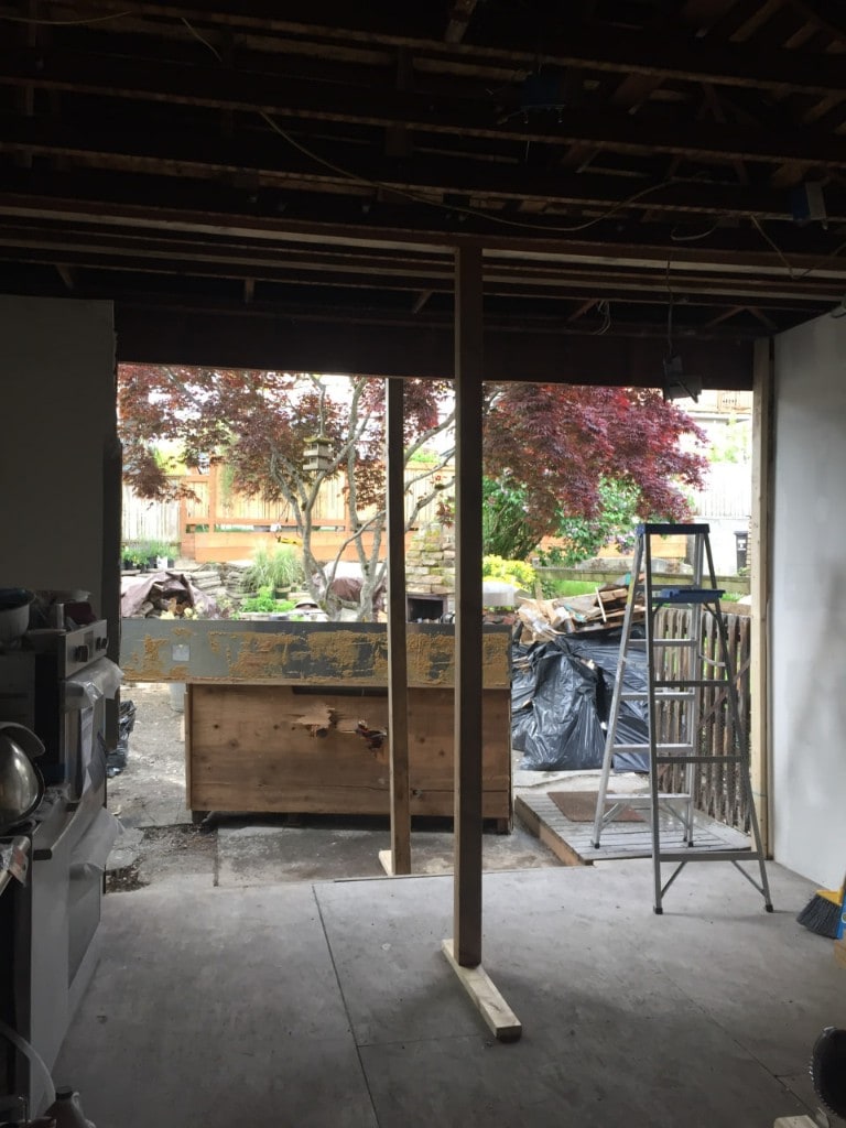 Rear wall opening to the backyard with shoring during interior demolition by Artbrick
