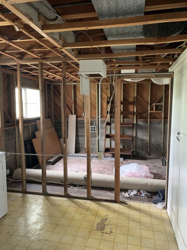 Room stripped to studs and diagonal plank sheathing during interior demolition by Artbrick