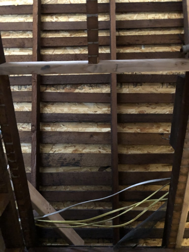 Exposed sheathing and beam during selective interior demolition by Artbrick