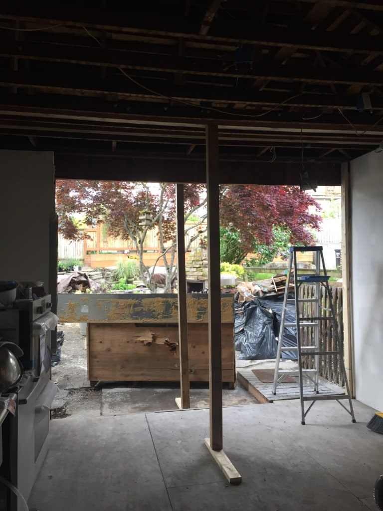 Wall opening with temporary support post during interior demolition by Artbrick
