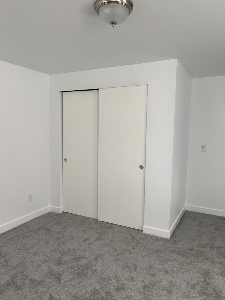 Bedroom with freshly painted walls, ceiling, and white sliding closet doors by Artbrick