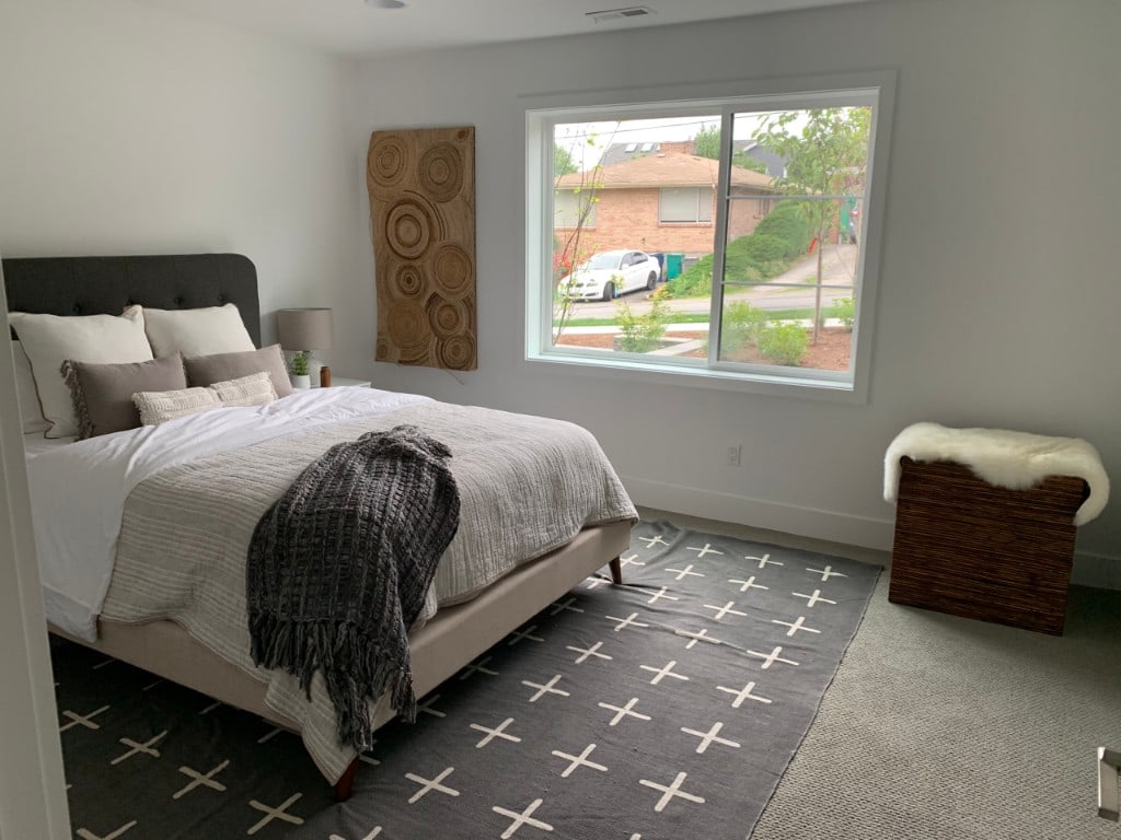 Renovated and staged master bedroom with a large window and fresh finishes by Artbrick