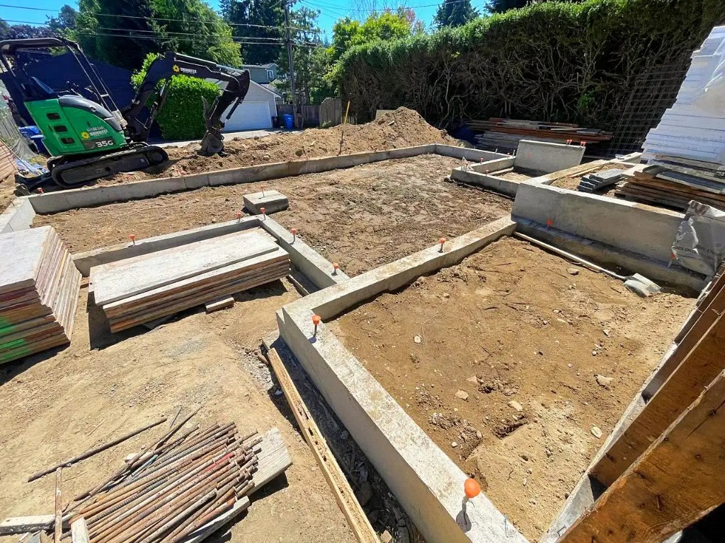 Foundation with stem walls, rebar, and mini excavator by Artbrick in Snohomish County